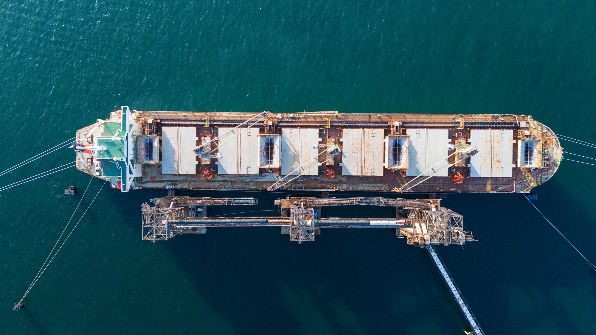 Aerial top view wood chips load chip from silo to cargo ship vessel concept green